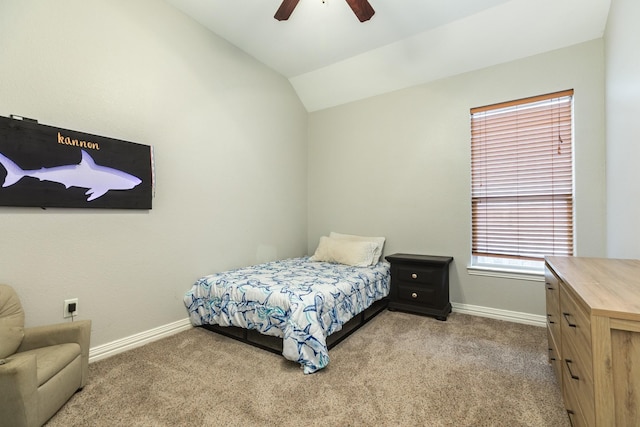 carpeted bedroom with vaulted ceiling, a ceiling fan, and baseboards