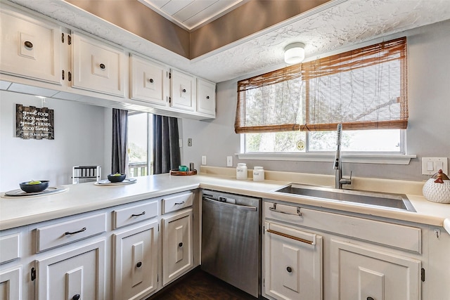 kitchen featuring a sink, white cabinets, light countertops, and dishwasher