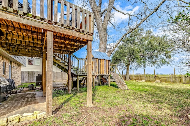 view of yard with a patio area, a fenced backyard, and a playground