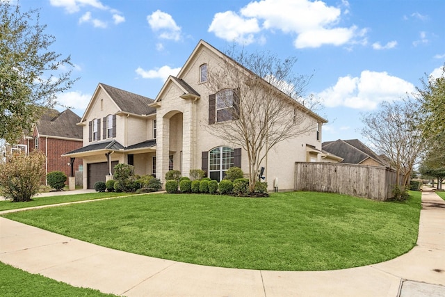 view of front facade featuring concrete driveway, an attached garage, fence, and a front yard