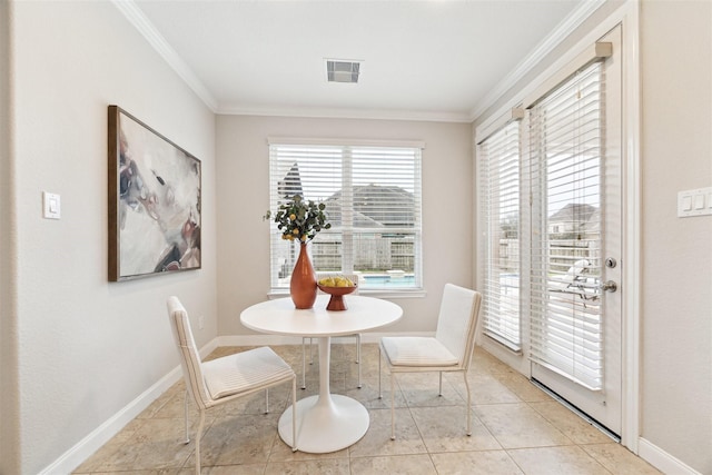 dining space with baseboards, light tile patterned flooring, visible vents, and crown molding