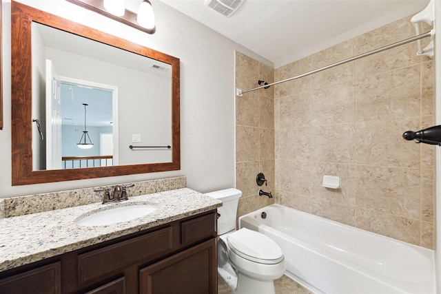 bathroom with toilet, vanity, shower / tub combination, and visible vents