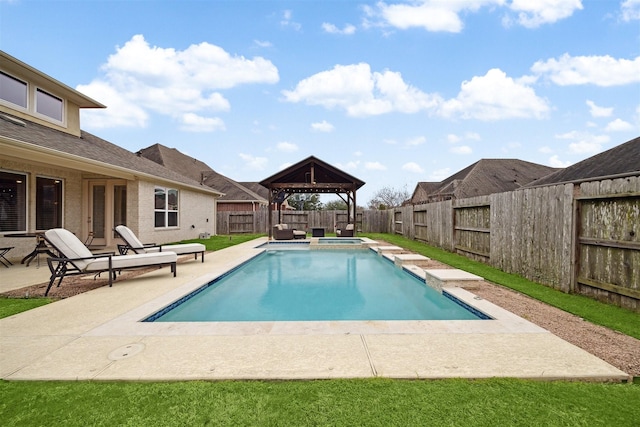 view of pool with a fenced backyard, a pool with connected hot tub, a patio, and a gazebo