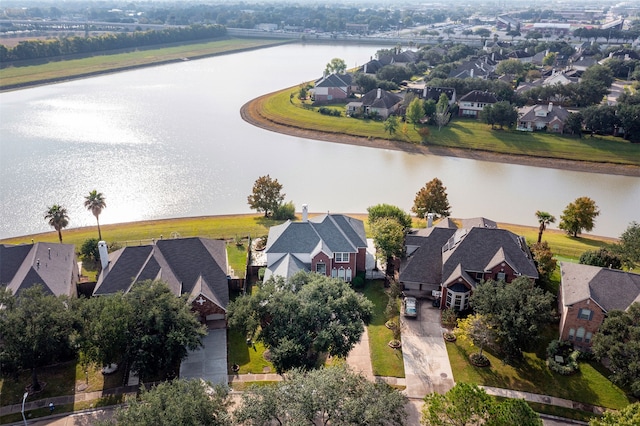 drone / aerial view featuring a water view and a residential view