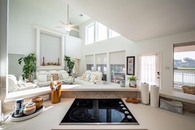 kitchen featuring visible vents, black electric stovetop, open floor plan, and light countertops