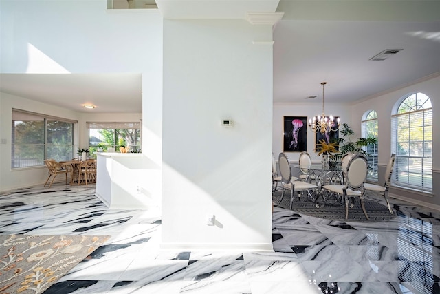 hall with a chandelier, marble finish floor, visible vents, and crown molding