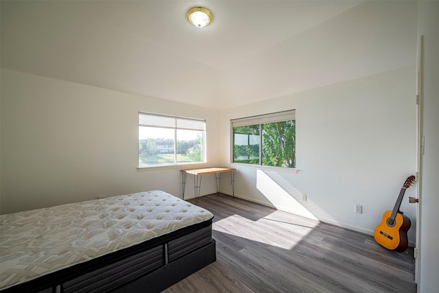 bedroom featuring wood finished floors and baseboards