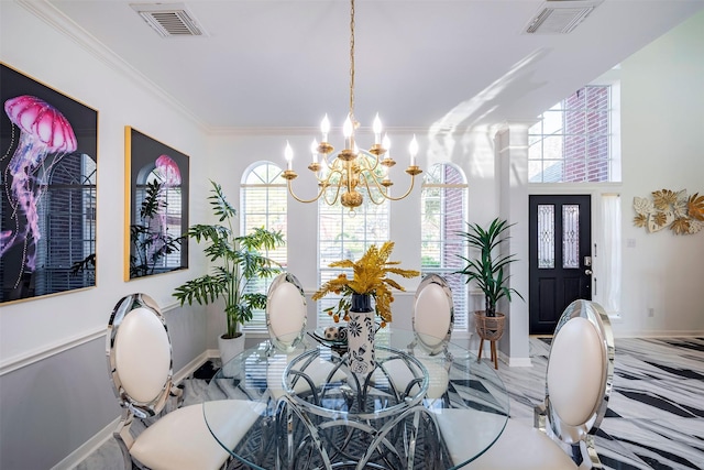 dining area with visible vents, crown molding, baseboards, and an inviting chandelier