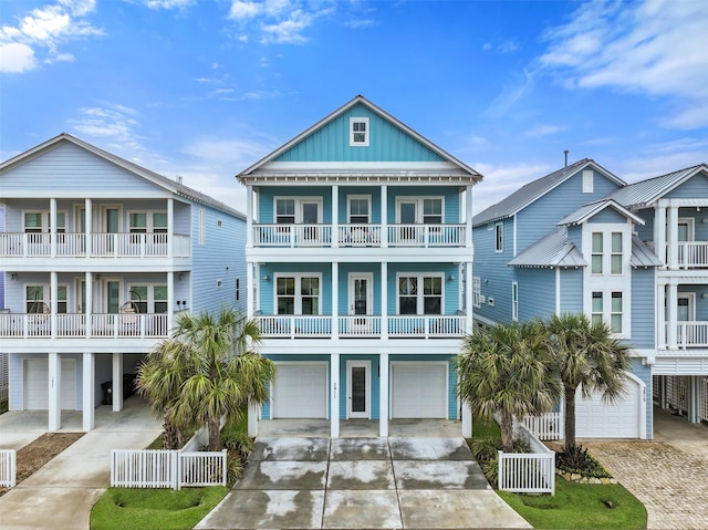 coastal inspired home featuring a garage, concrete driveway, and board and batten siding