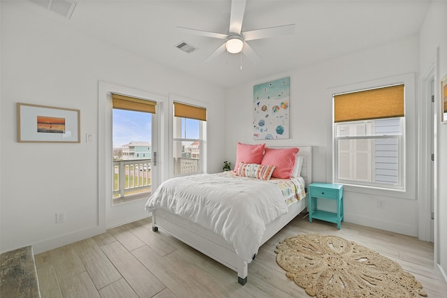 bedroom featuring access to exterior, baseboards, and light wood-style floors