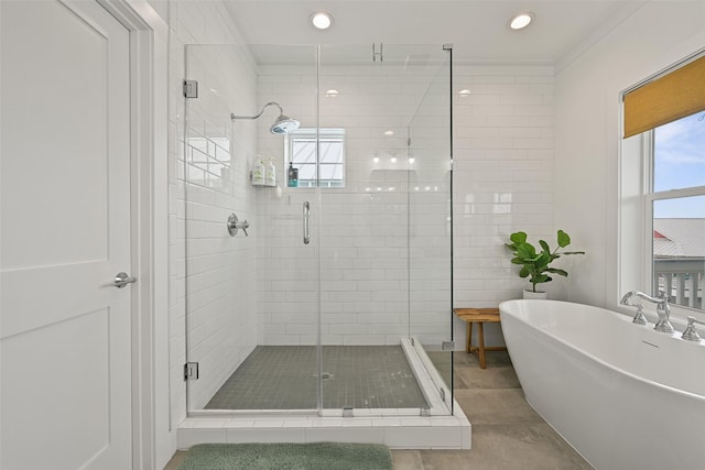 bathroom featuring a soaking tub, a shower stall, and recessed lighting