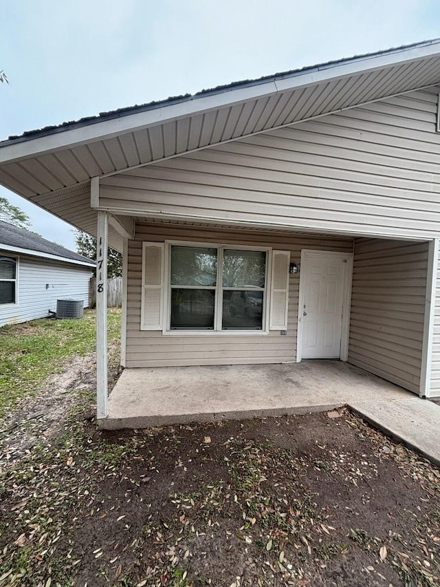 property entrance with a patio area and central air condition unit