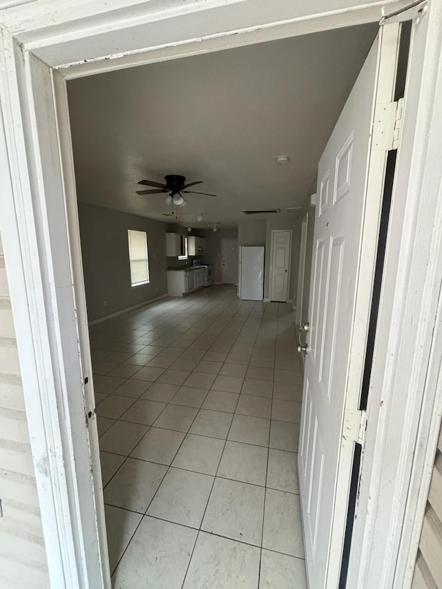 hallway featuring light tile patterned flooring