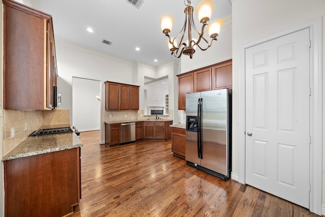 kitchen featuring dark wood-style flooring, visible vents, appliances with stainless steel finishes, and a sink