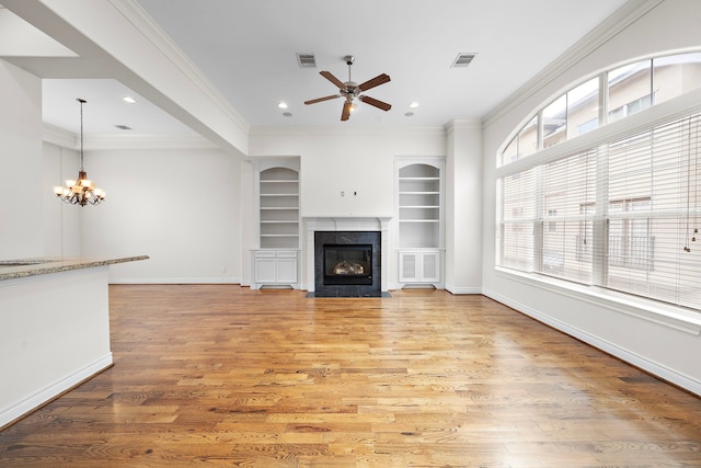 unfurnished living room featuring visible vents, light wood-style flooring, and crown molding