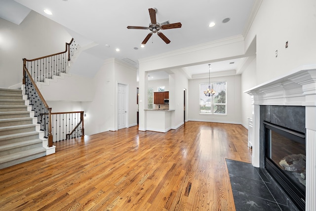 unfurnished living room with ornamental molding, a fireplace, baseboards, and wood-type flooring