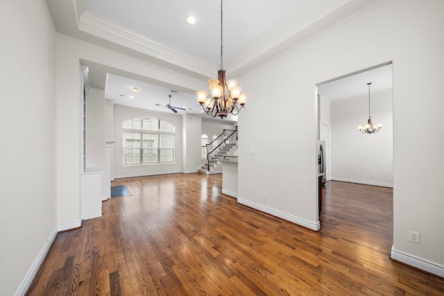 unfurnished dining area featuring stairway, wood finished floors, baseboards, and ornamental molding