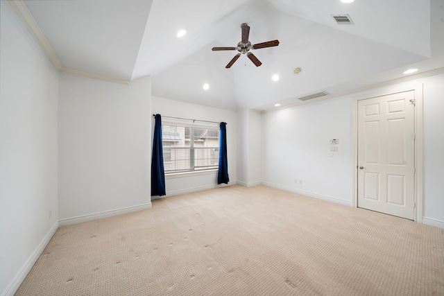 spare room with lofted ceiling, baseboards, visible vents, and light carpet