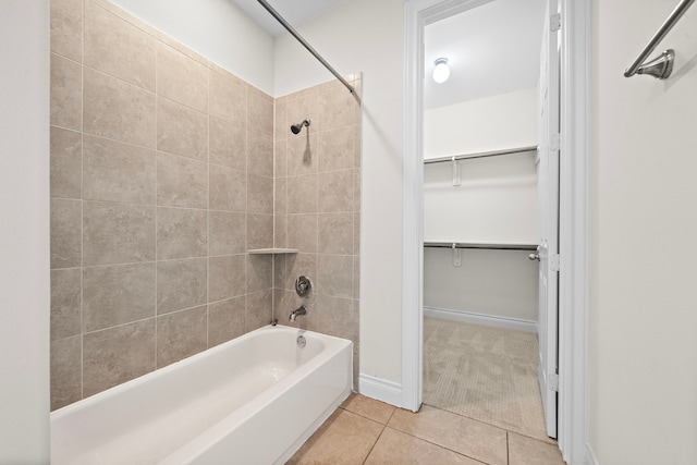 bathroom featuring tile patterned floors, baseboards, a spacious closet, and  shower combination