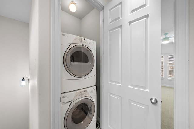 washroom with stacked washer / drying machine and laundry area