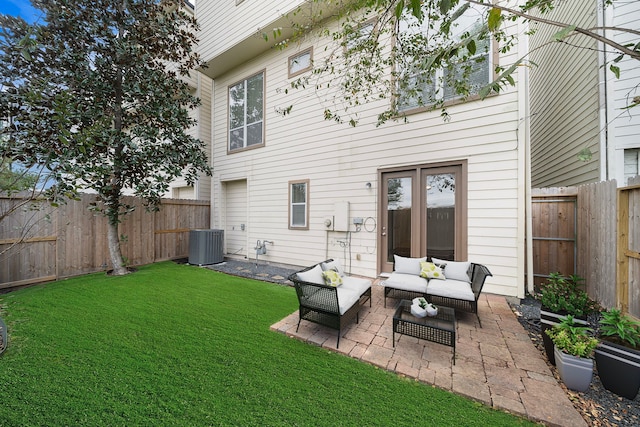 rear view of property with an outdoor living space, a lawn, a fenced backyard, and a patio area