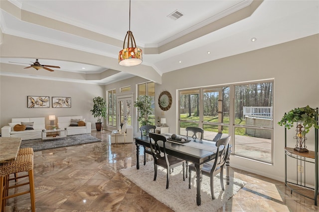 dining room featuring visible vents, baseboards, marble finish floor, ornamental molding, and a raised ceiling