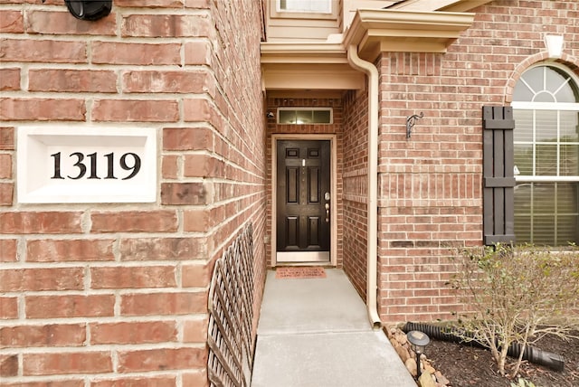 property entrance with brick siding