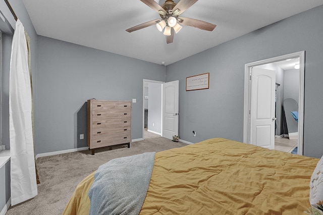 bedroom featuring a ceiling fan, light carpet, and baseboards