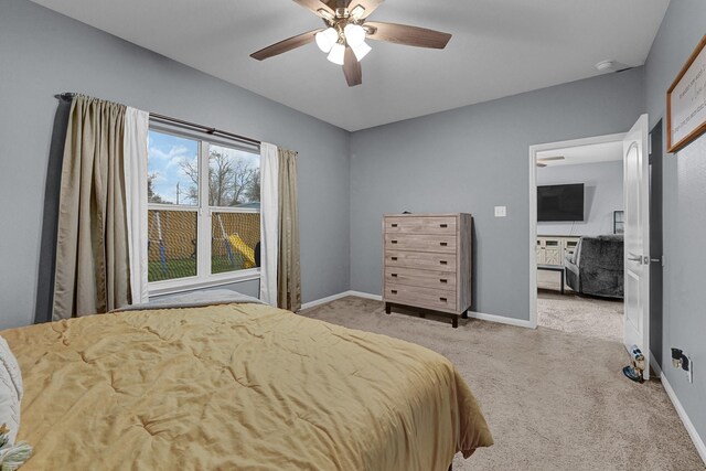 bedroom featuring light carpet, ceiling fan, and baseboards