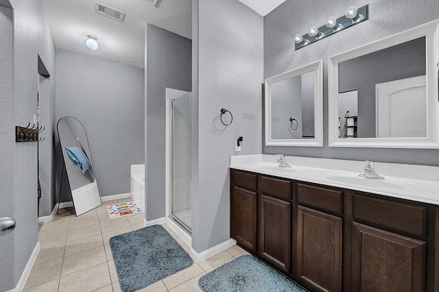 bathroom with a stall shower, visible vents, a bath, tile patterned flooring, and a sink