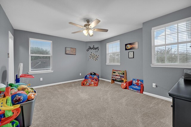 game room with carpet, baseboards, and a ceiling fan