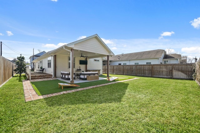 rear view of house with ceiling fan, a patio, a fenced backyard, an outdoor hangout area, and a yard