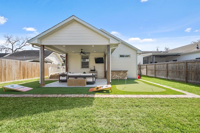 rear view of house with a patio, a fenced backyard, an outdoor living space, a ceiling fan, and a yard