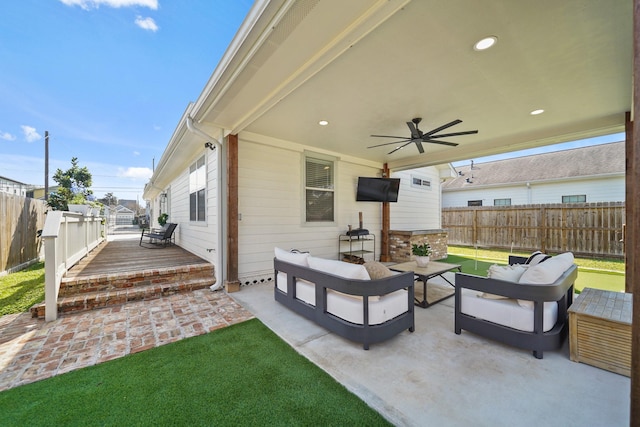 view of patio / terrace with a ceiling fan, a fenced backyard, a deck, and an outdoor hangout area