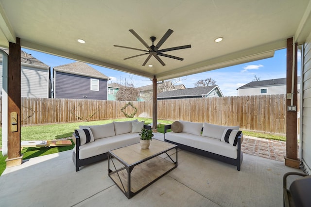 view of patio / terrace with ceiling fan, an outdoor living space, and a fenced backyard