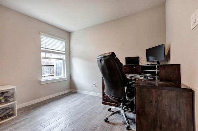 office featuring light wood-type flooring and baseboards