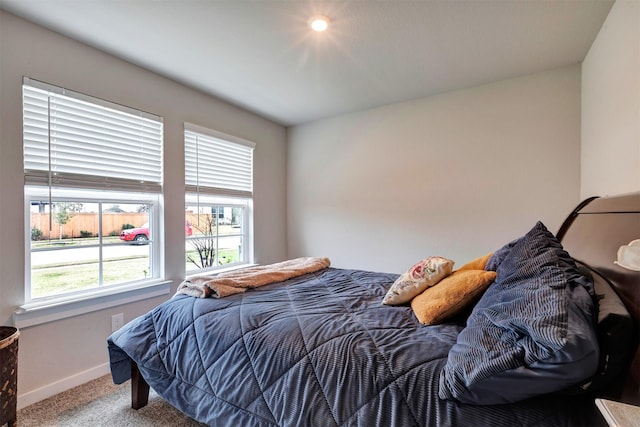 carpeted bedroom featuring baseboards