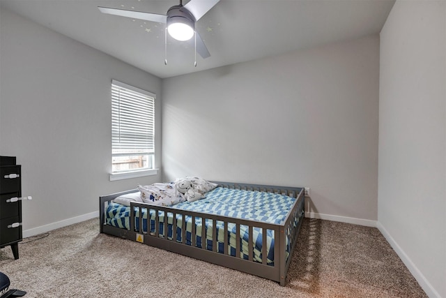 carpeted bedroom featuring ceiling fan and baseboards