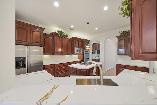 kitchen featuring arched walkways, recessed lighting, stainless steel appliances, a sink, and visible vents