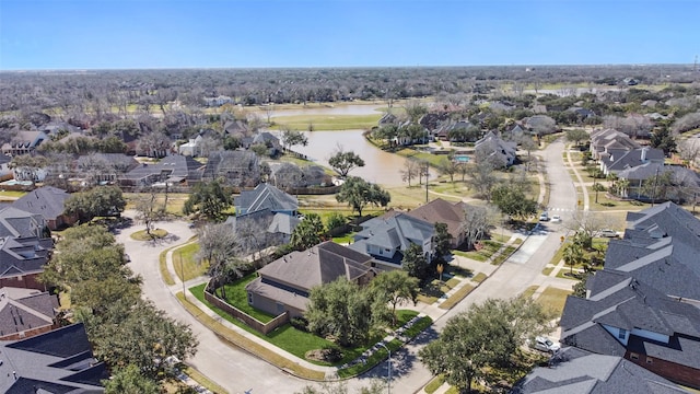 drone / aerial view featuring a residential view and a water view