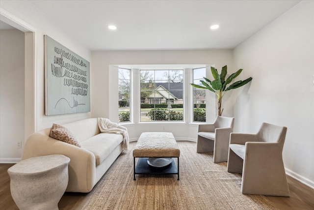 living area featuring baseboards, wood finished floors, and recessed lighting