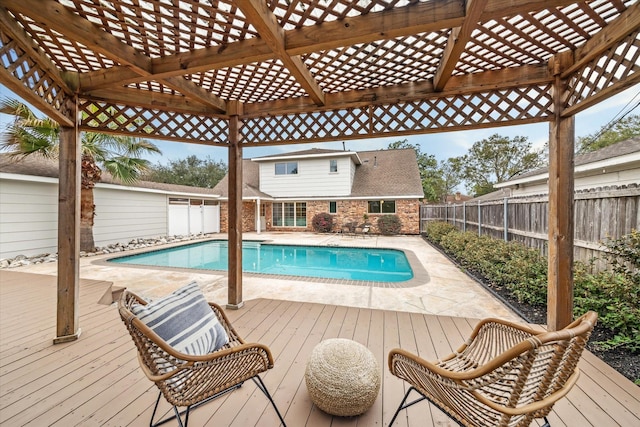 view of pool with a wooden deck, a fenced backyard, a fenced in pool, and a pergola