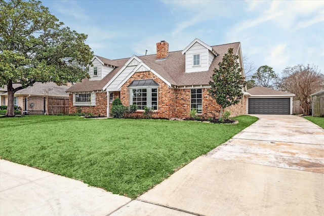 new england style home featuring a garage, brick siding, fence, a front lawn, and a chimney