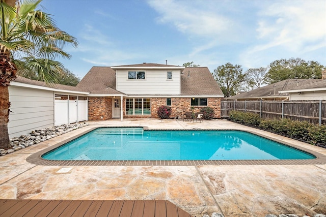 view of pool with a fenced in pool, fence, and a patio