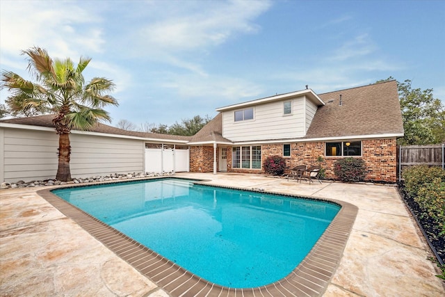 view of swimming pool with a patio, fence, and a fenced in pool