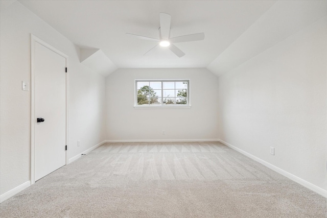 additional living space featuring vaulted ceiling, ceiling fan, and light carpet