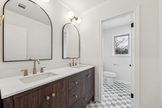 bathroom with crown molding, a sink, visible vents, and tile patterned floors