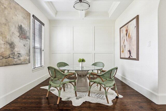 dining area with baseboards, coffered ceiling, dark wood finished floors, ornamental molding, and a decorative wall