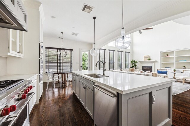 kitchen featuring visible vents, light countertops, a sink, and pendant lighting