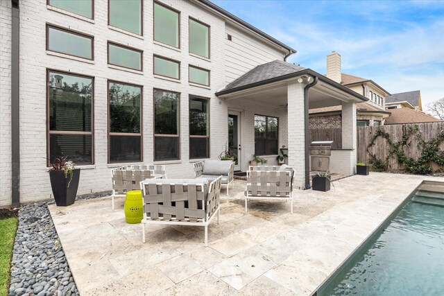 view of patio featuring outdoor lounge area, area for grilling, a fenced backyard, and a fenced in pool